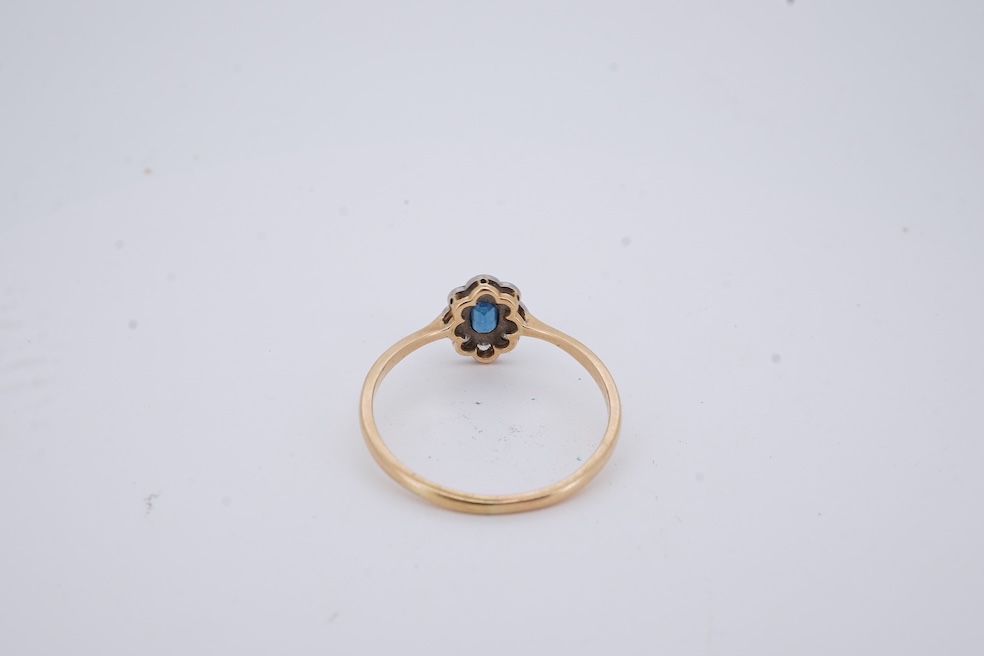 A 1920's yellow metal, stamped 18ct, sapphire and diamond set oval cluster ring, size V, gross weight 2.3 grams. Condition - poor to fair